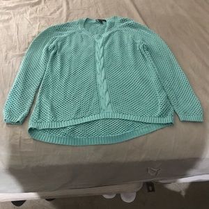 A teal perforated sweater.